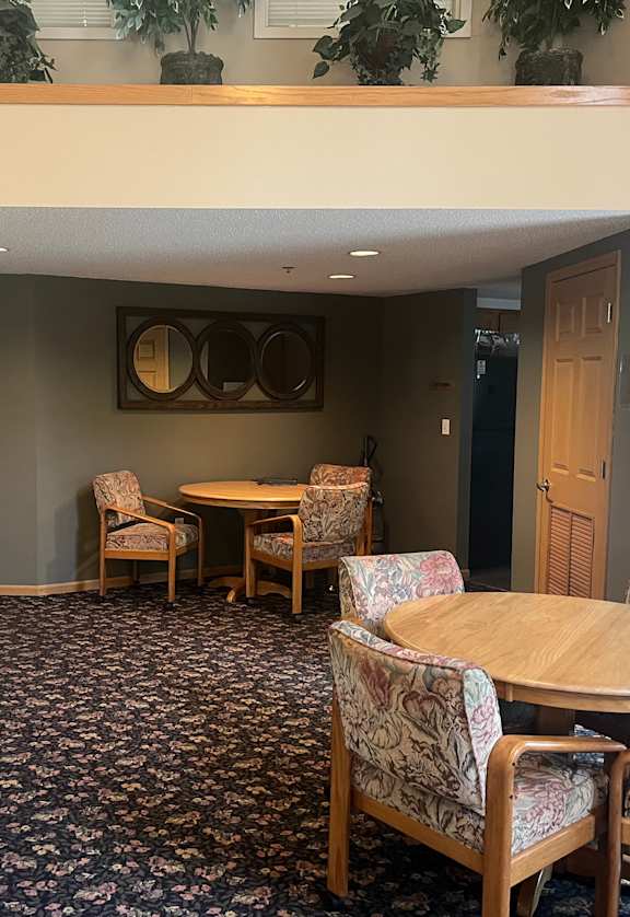 A room with a table and chairs.