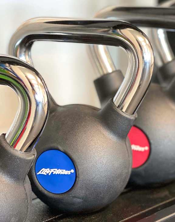 A gym with treadmills and elliptical machines at 42 Hundred On The Lake, St Francis, WI