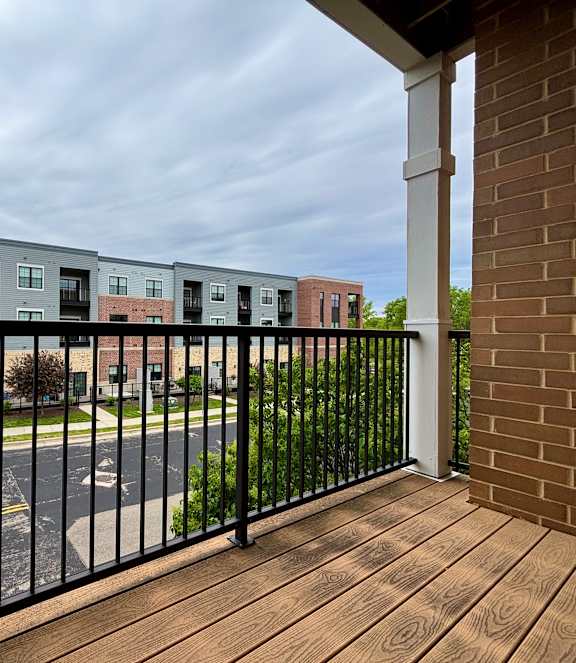 A long hallway with a blue ceiling and a door at the end.