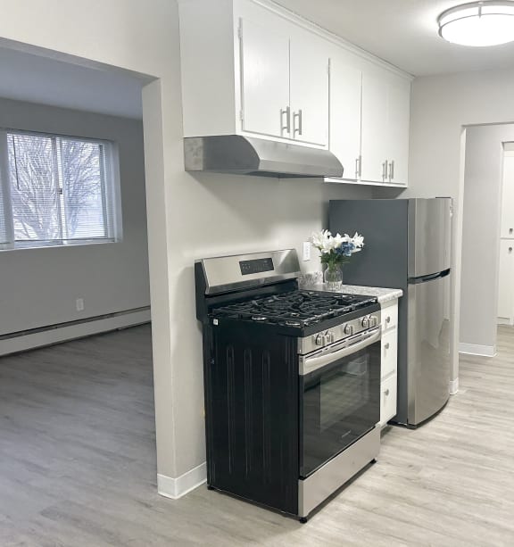 a kitchen with white appliances and wooden cabinets