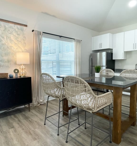 a covered patio with couches and chairs and a tv at Emery Village, Concord