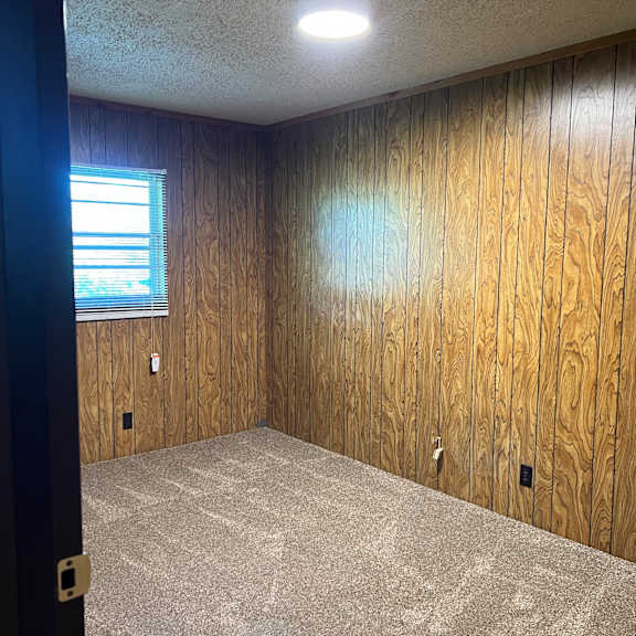 a gym with cardio equipment and weights on the floor