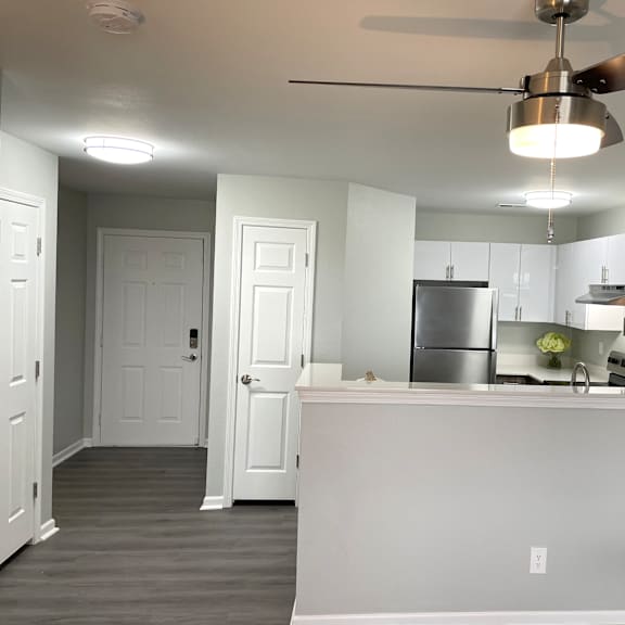 A kitchen with a white counter and a ceiling fan.at Vita on Grant, Merrillville, 46410