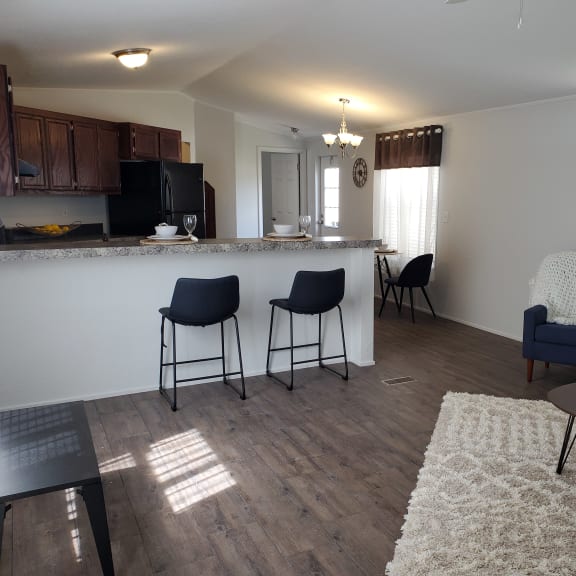 an open floor plan with a kitchen and living room at West Winds in Cheyenne, WY
