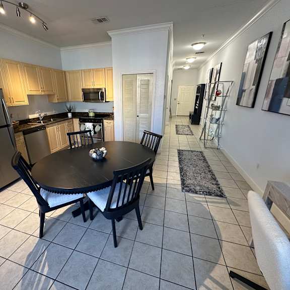 A kitchen with a table and chairs.