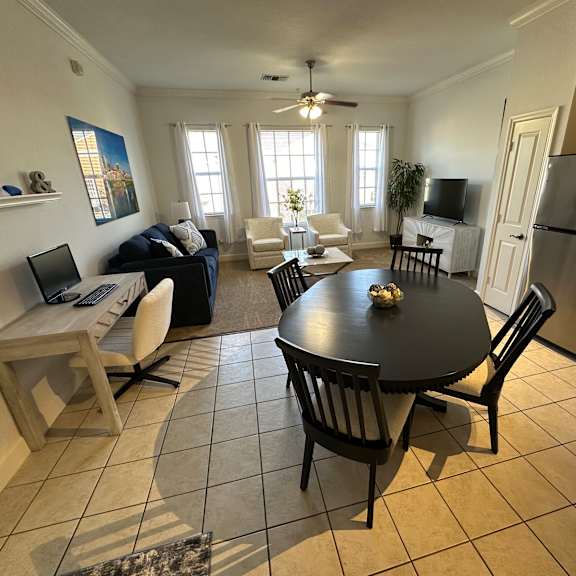A kitchen with a table and chairs in the middle of the room.