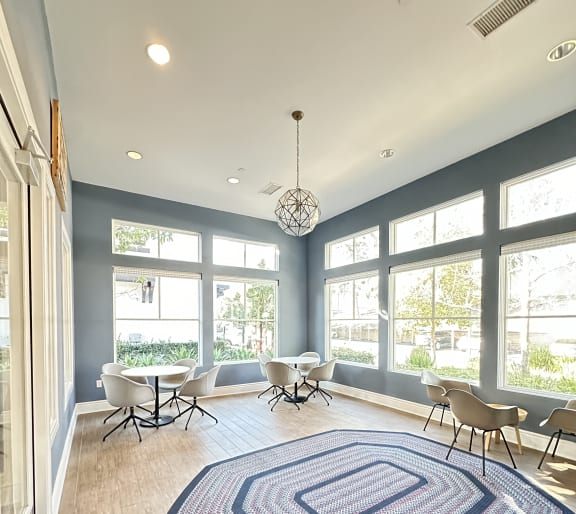 a sitting area in a clubhouse with rug and chairs at The Bryant Apartments at Yorba Linda, Yorba Linda, CA