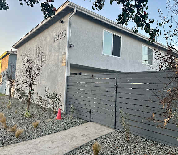 A grey house with the number 1030 on it.