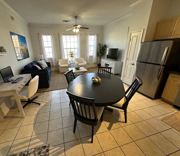 A kitchen with a table and chairs in the middle of the room.