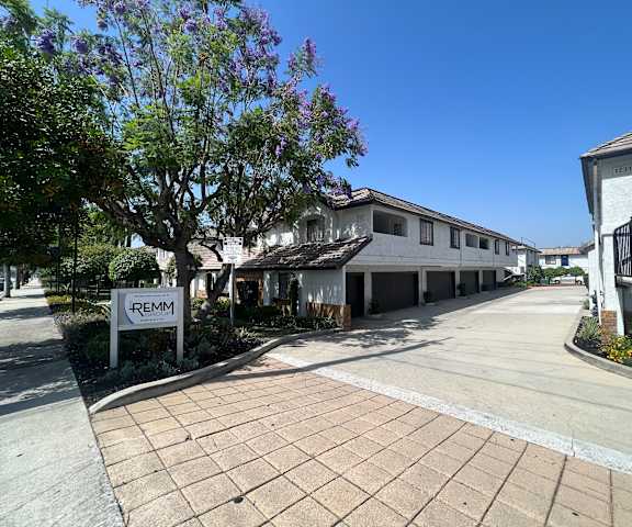 A sign that says REMM is in front of a building.