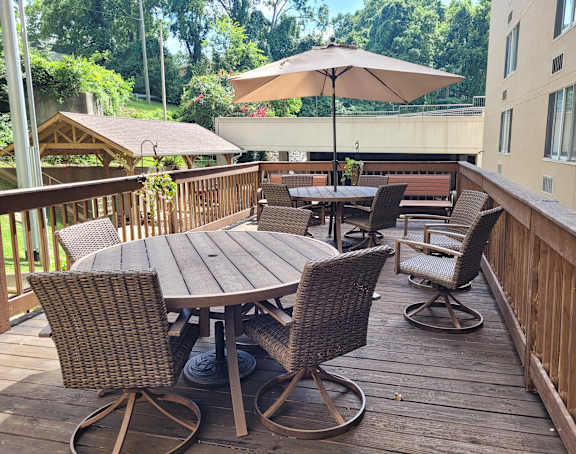 a large wooden deck with tables and chairs