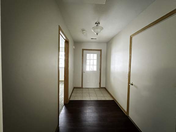 A long hallway with a door at the end.