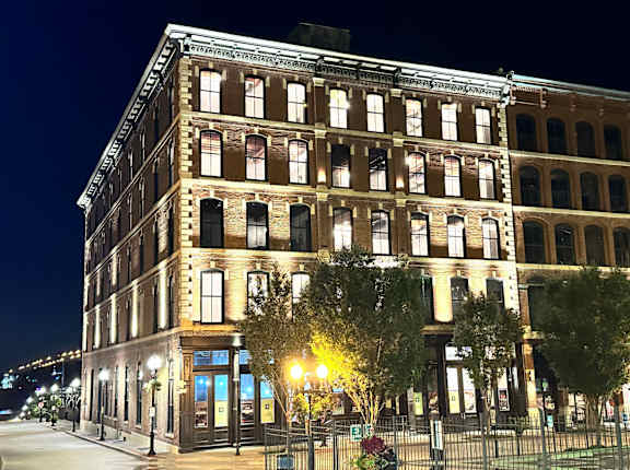 a large building on a city street at night