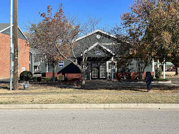 a man standing in front of a building at Emerald Greens, Norman Oklahoma