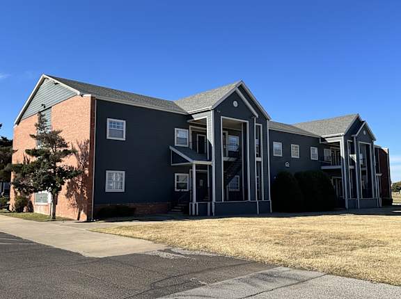 an apartment building with a blue sky in the background at Emerald Greens, Norman Oklahoma