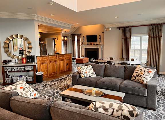 A living room with a grey couch and a wooden cabinet.