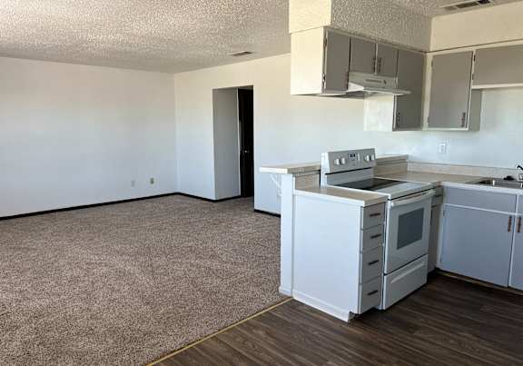 a dining room and kitchen with a table and chairs