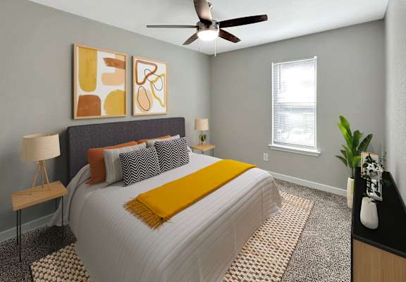 a bedroom with a large bed and a ceiling fan