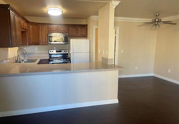 an empty kitchen with an island in the middle of it