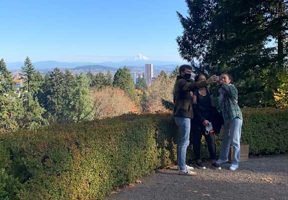 A group of people taking a selfie in a park.