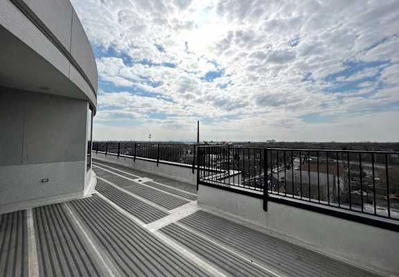 Penthouse balcony at Highpoint Jefferson Park apartments in Chicago with private outdoor space and skyline views