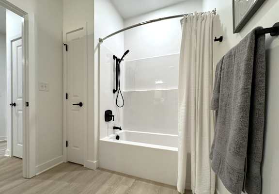 Typical second bathroom with tub/shower combo and linen closet