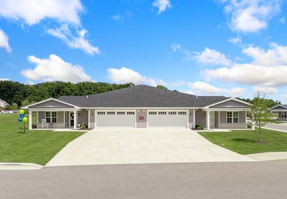 the front of a house with a driveway and lawn at Morada at Maysville, Fort Wayne, Indiana