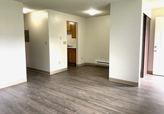 A room with a wooden floor and white walls.