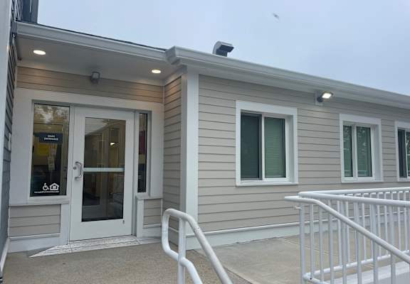 a home with a front door and a ramp to a porch