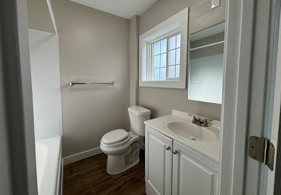 an empty bathroom with a toilet and a sink