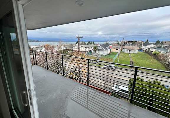 a balcony with a view of a city and the ocean