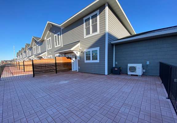 a large driveway with a house in the background