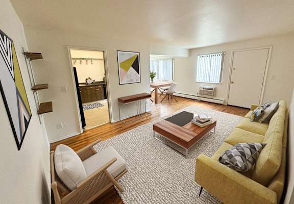 the living room of an apartment with a couch and a table at The Lodge Apartments