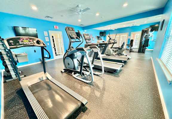 the gym is equipped with cardio machines and televisions