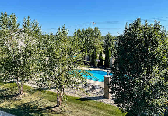 a backyard with a swimming pool and trees at Hawthorne Properties in Lafayette, IN 47905