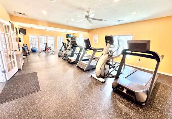 A gym with treadmills, elliptical machines, and other exercise equipment.  at Hawthorne Properties in Lafayette, IN 47905