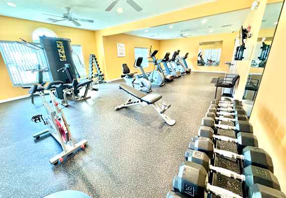 A gym with a variety of equipment including treadmills, stationary bikes, and dumbbells. at Hawthorne Properties in Lafayette, IN 47905