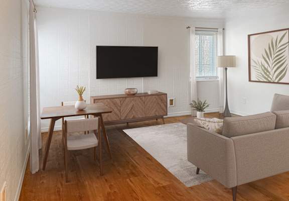 A living room with a couch, chair, and television.