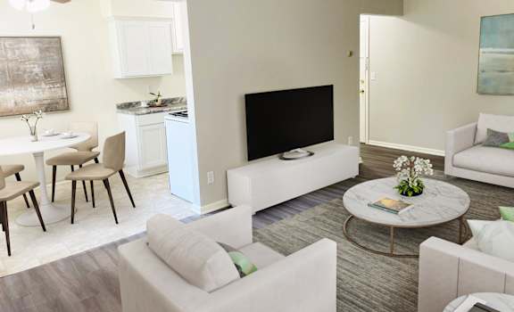 a living room with couches a table and chairs and a flat screen tv