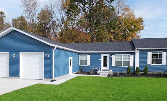 a blue house with a lawn in front of it at Hangar Flats, Batavia