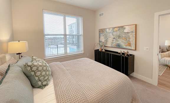 a bedroom with a large bed and a ceiling fan