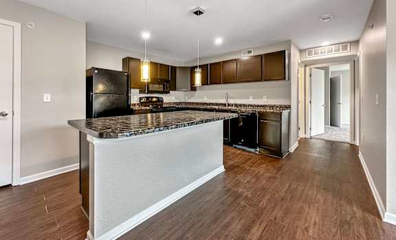 A Kitchen With a Refrigerator at Capitol Grove Apartments, Iowa, 50317