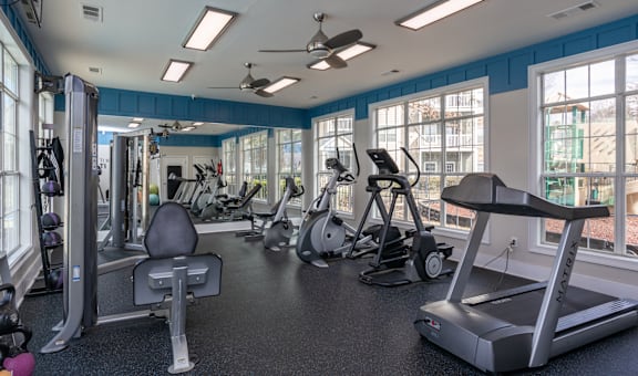 A spacious gym with a variety of equipment including treadmills, weights, and exercise machines.