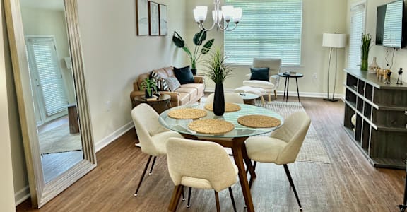 A dining room with a table set for six.