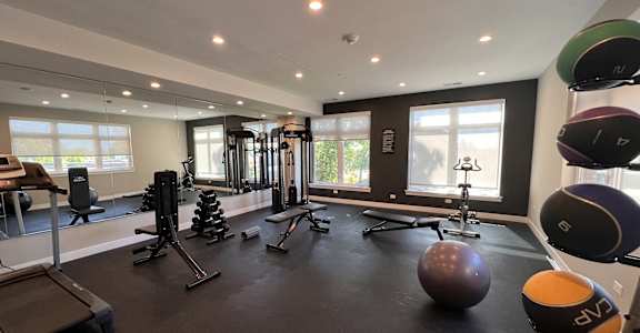 a workout room with weights and other exercise equipment in a building