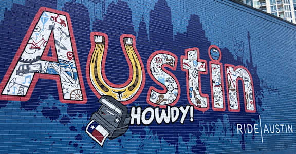a mural on the side of a building with the words painted