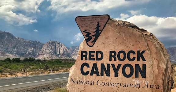 A large rock with the words "Red Rock Canyon National Conservation Area" written on it.