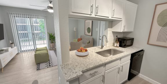 a kitchen with white cabinets and a granite counter top