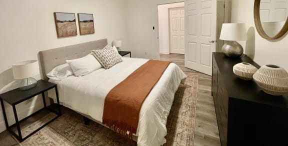 a bedroom with a bed and a ceiling fan  at Polo Villas, Bakersfield