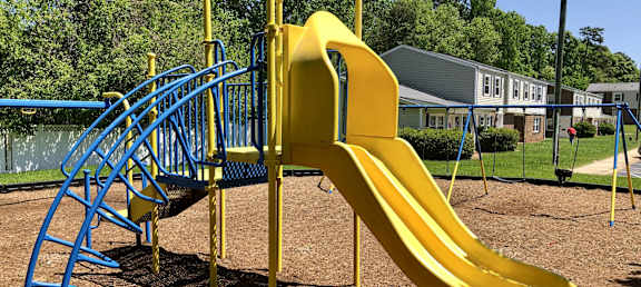 a playground with a slide at a park at Colony Townhomes, Raleigh, NC, 27609